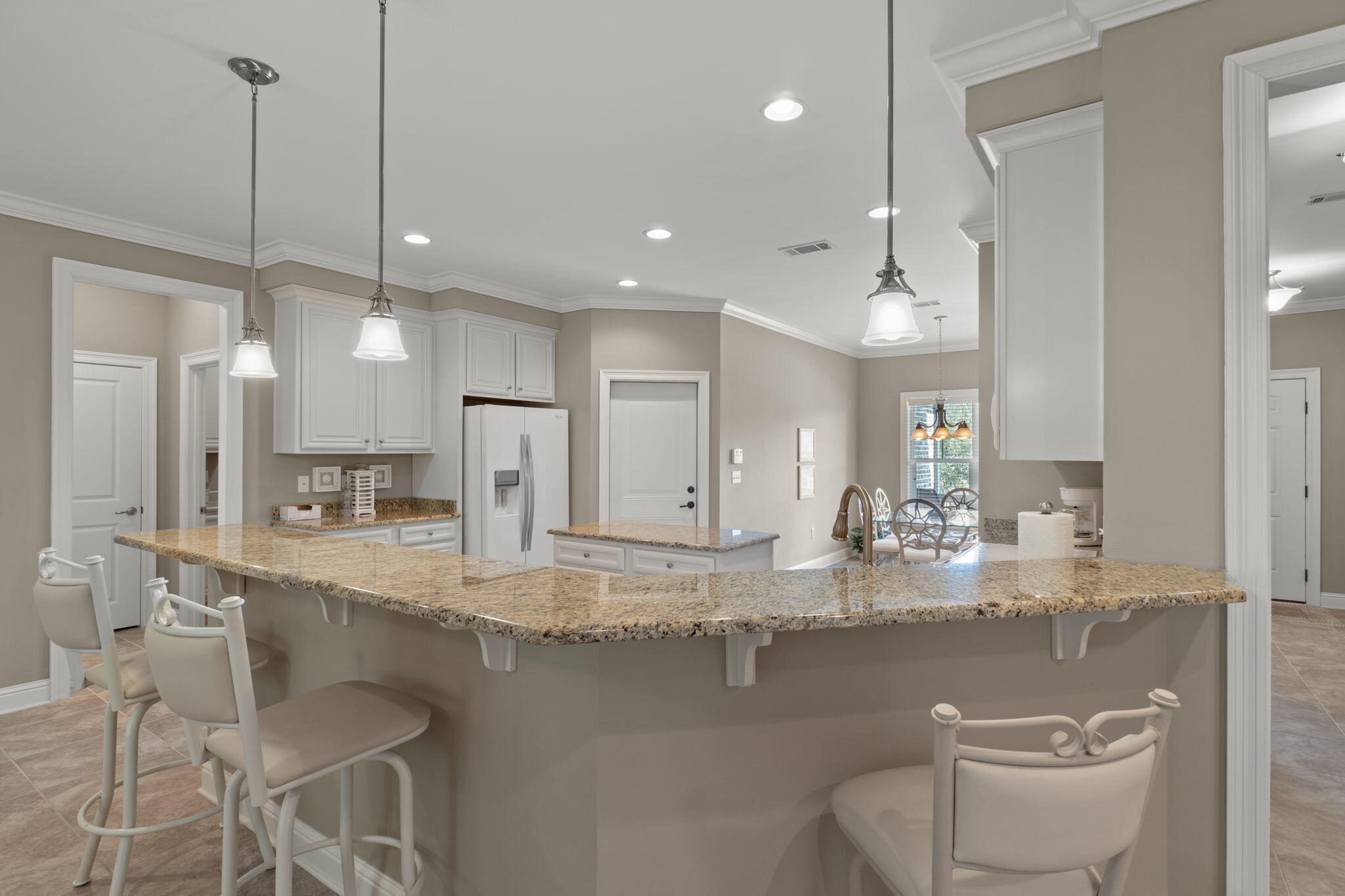 562 Falcon Trail Niceville, FL 32578 - Photo 9 of 40 a kitchen with kitchen island a sink and a stove