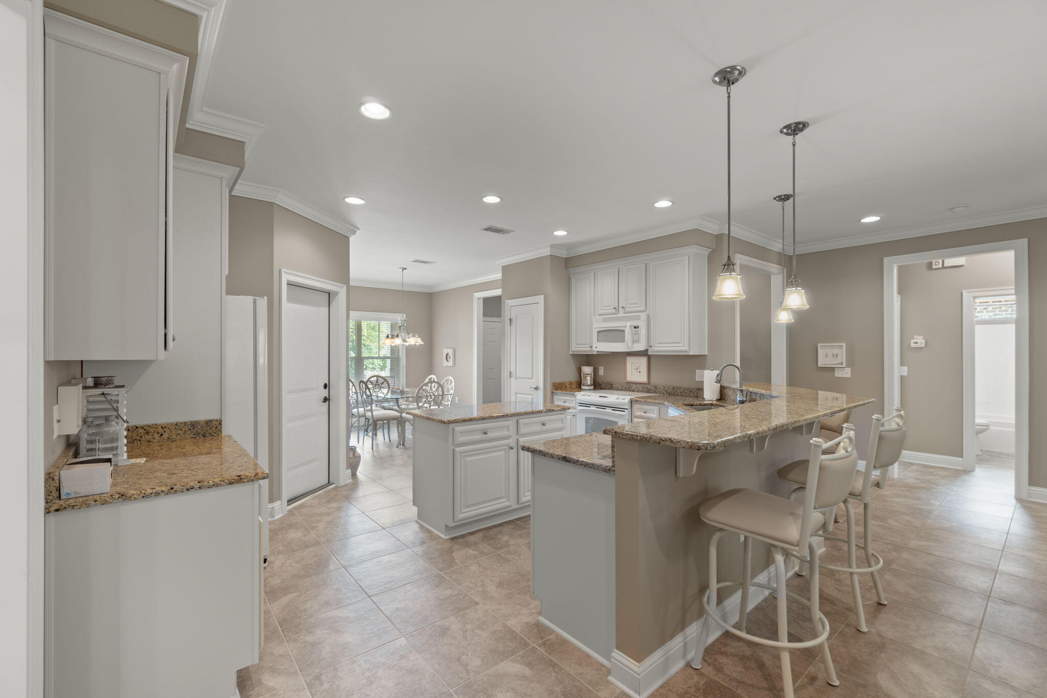 562 Falcon Trail Niceville, FL 32578 - Photo 10 of 40 a kitchen with stainless steel appliances kitchen island granite countertop a sink and cabinets