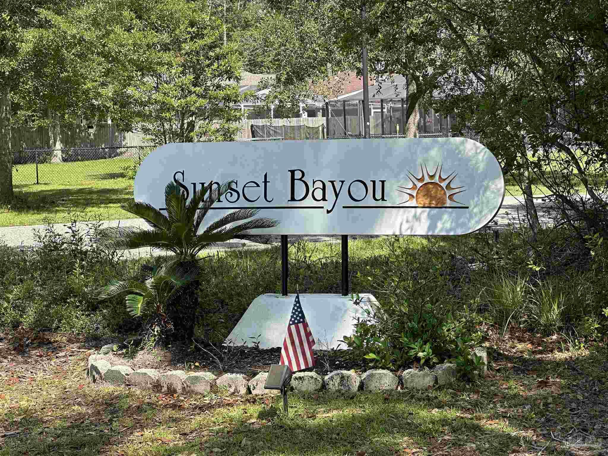 Lot 7 Sunset Bayou Drive Milton, FL 32583 - Photo 2 of 19 a sign that is sitting on a brick wall