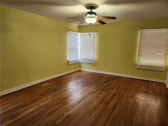 a view of a room with wooden floor and windows