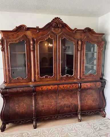 a view of a house with a car park side of a road