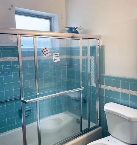 a bathroom with a shower and toilet