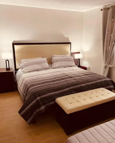 a bedroom with a bed and a night stand