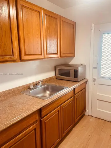 a kitchen with stainless steel appliances granite countertop wooden cabinets a sink and dishwasher