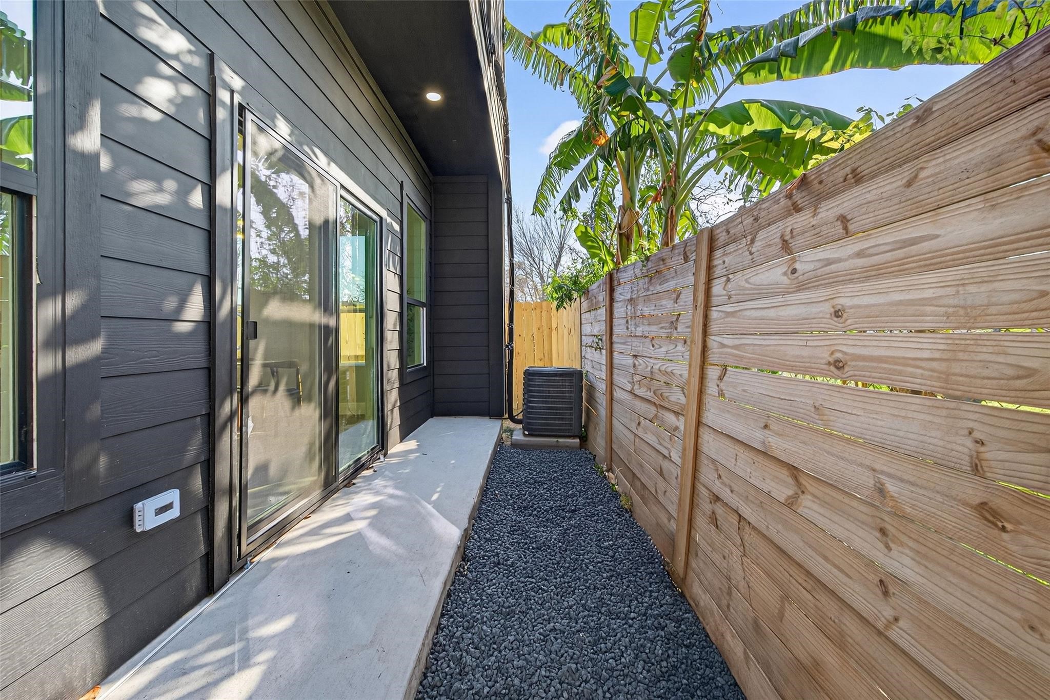 4115 Yale Street Houston, TX 77018 - Photo 22 of 35 Private outdoor yard with sliding glass door access full wood privacy fencing—ideal for pets, morning coffee, or seamless indoor-outdoor living.