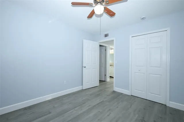a view of room with a chandelier fan and wooden floor