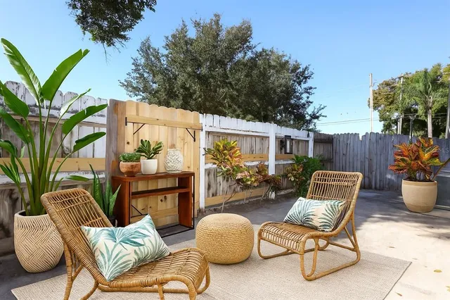a outdoor living space with furniture potted plant and a large window