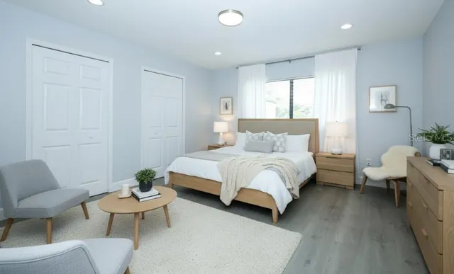 a bedroom with a bed and a couch