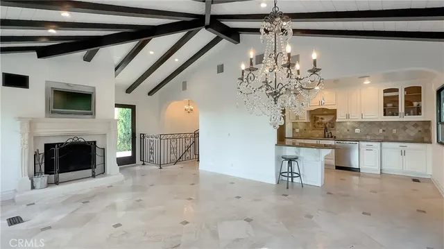 a kitchen with stainless steel appliances granite countertop a sink a stove and a refrigerator