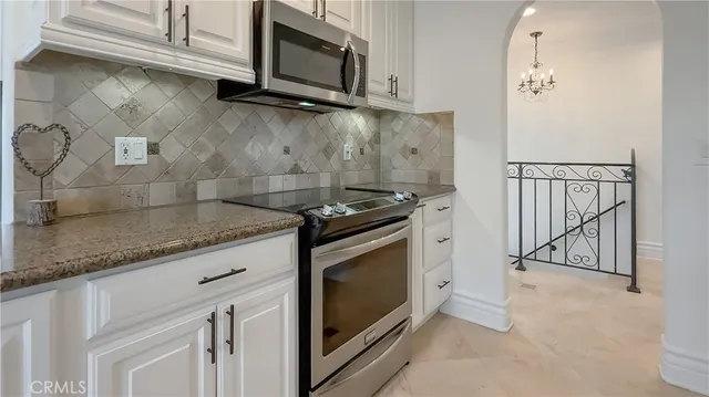 a bathroom with a tub a mirror and a shower