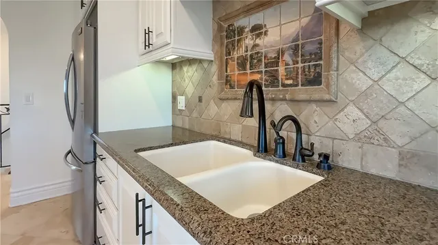 en empty room with a chandelier fan