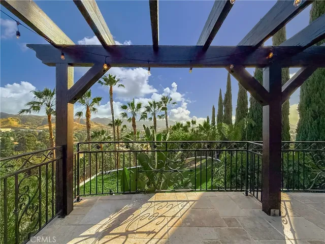 a view of a livingroom with a fireplace wooden floor and a ceiling fan