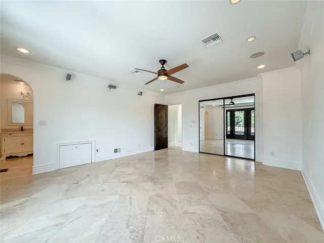 a view of an empty room with wooden floor fireplace and a window