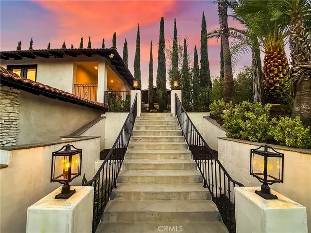 a view of a balcony with wooden floor and potted plants