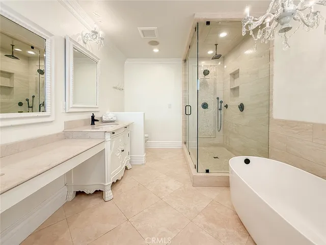 a bathroom with a sink vanity mirror and toilet