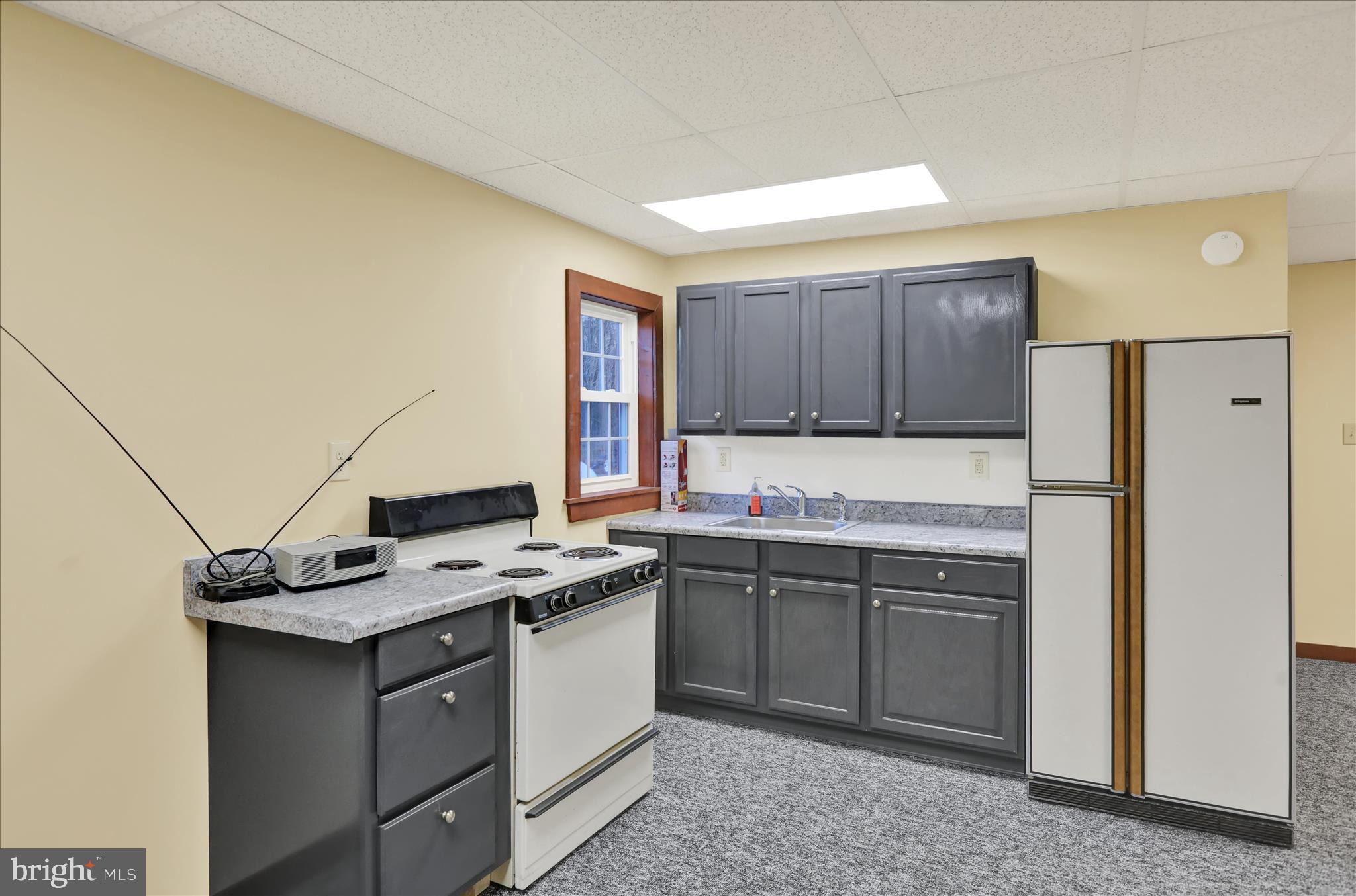 392 5 Locks Road Shoemakersville, PA 19555 - Photo 3 of 11 a kitchen with stainless steel appliances granite countertop a sink stove and refrigerator