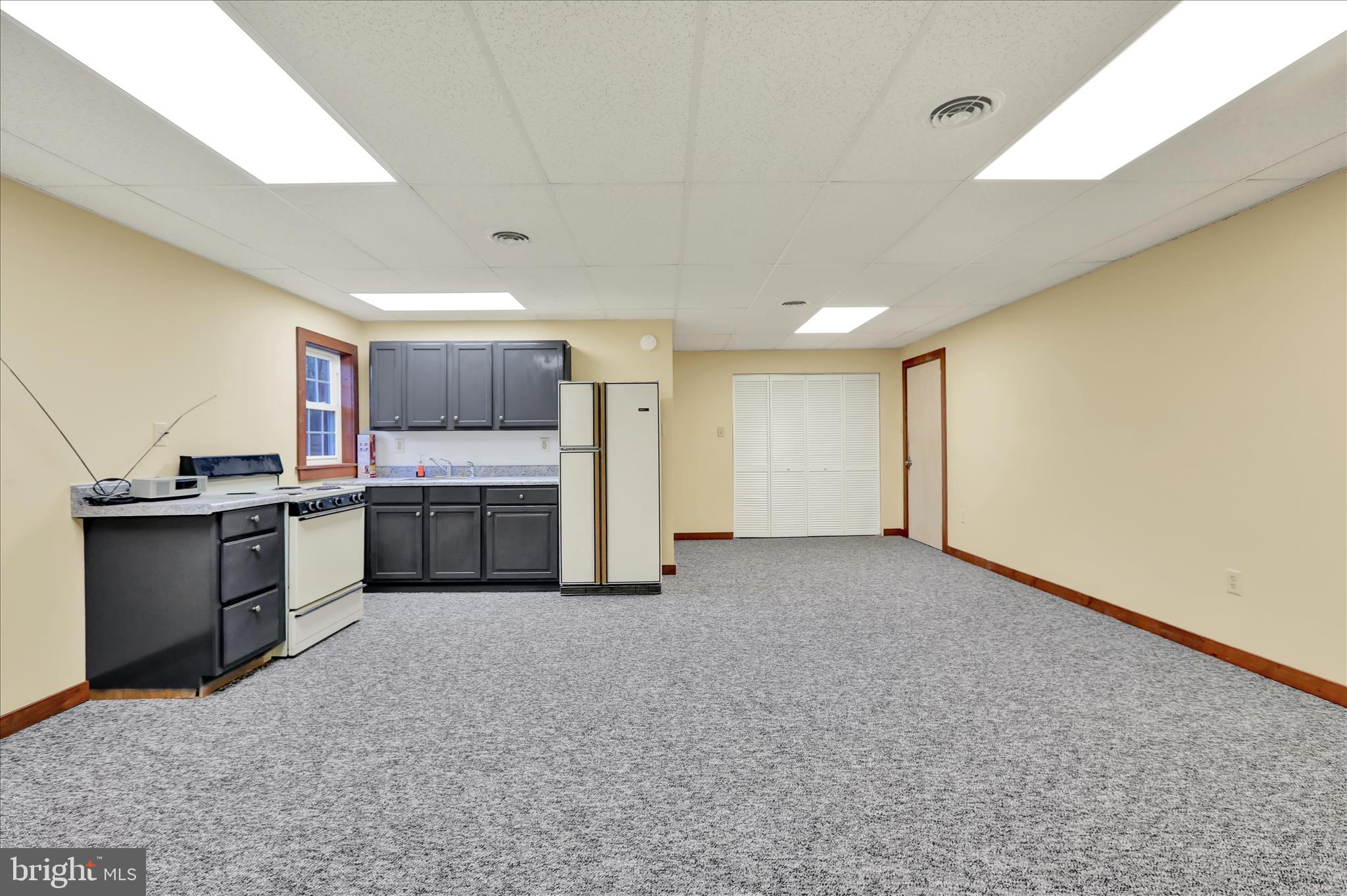 392 5 Locks Road Shoemakersville, PA 19555 - Photo 5 of 11 a view of a kitchen with a sink and white cabinets