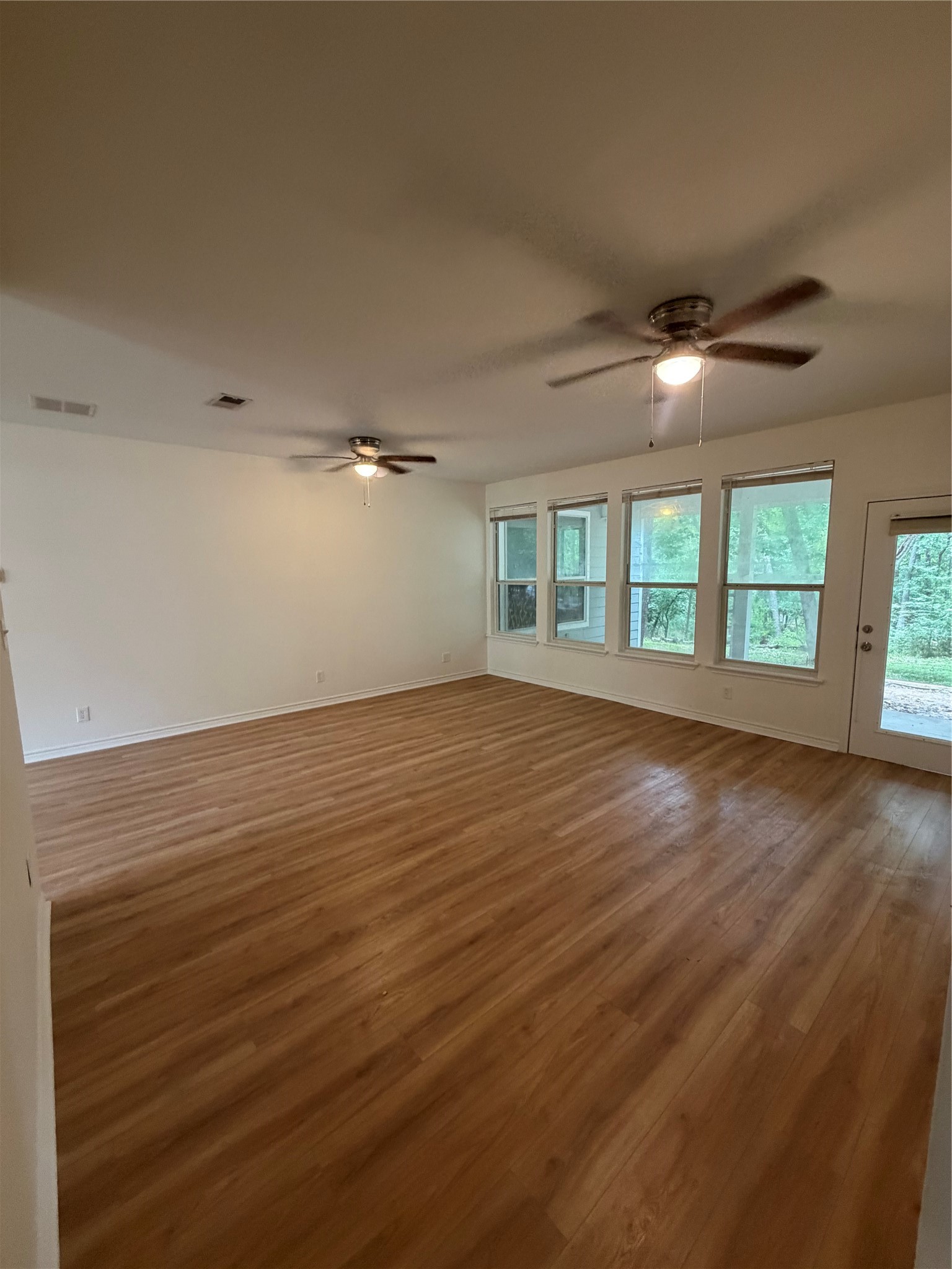 11 Lords Circle Coldspring, TX 77331 - Photo 5 of 27 Updated living room with vinyl flooring and fresh paint