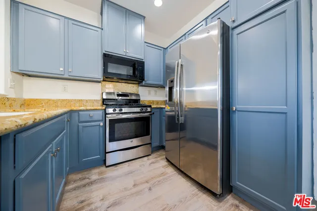 a kitchen with stainless steel appliances a stove sink and refrigerator