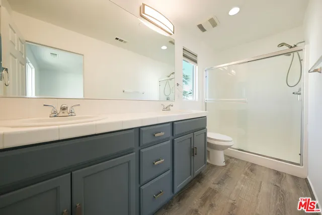 a bathroom with a sink a mirror and a shower