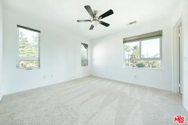 a view of empty room with ceiling fan