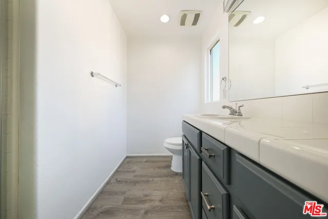 a bathroom with a sink a mirror and a shower