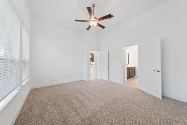 a view of a livingroom with a ceiling fan and window