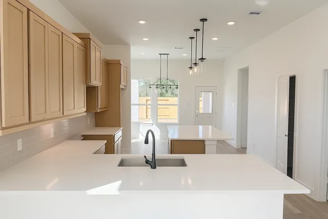 a large white kitchen with a large window