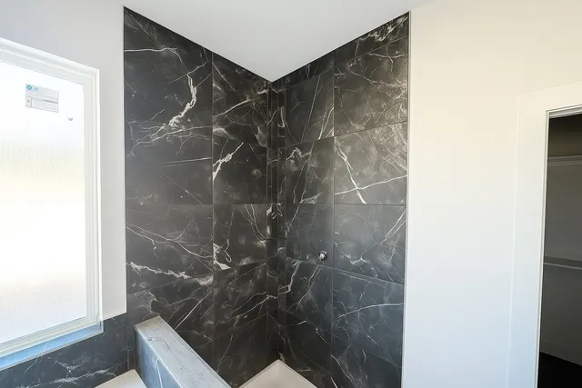 a bathroom with a shower and toilet