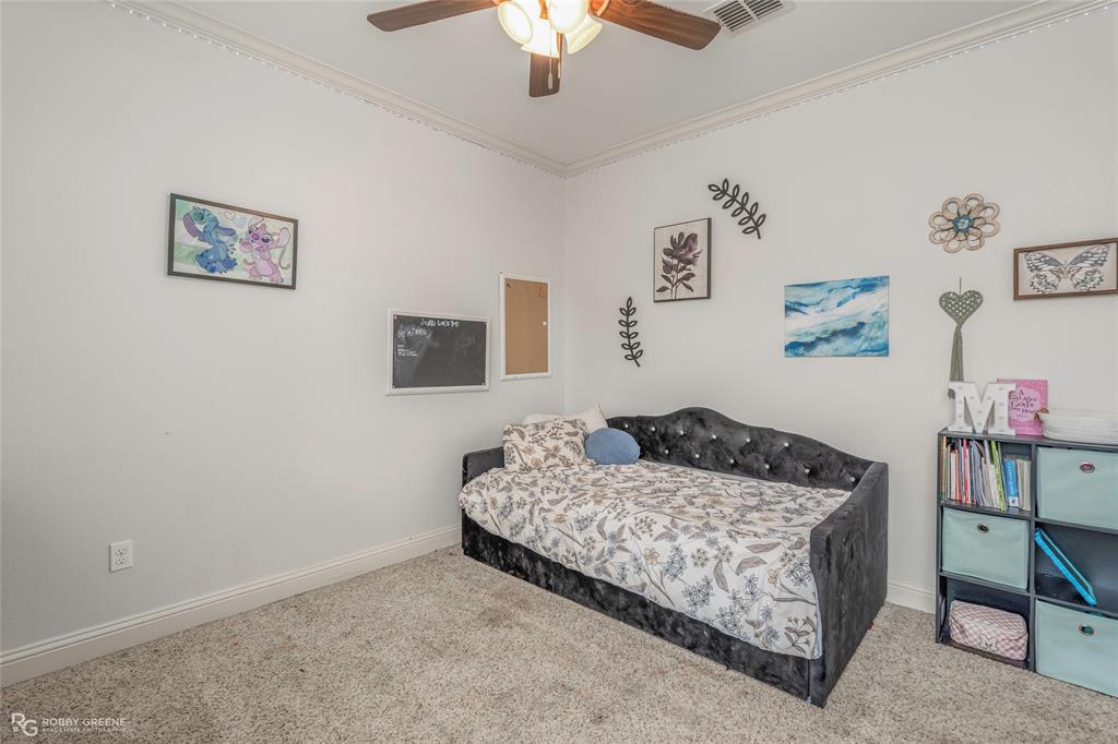 711 Reeds Reef Bossier City, LA 71112 - Photo 23 of 36 a bedroom with a bed and a chandelier