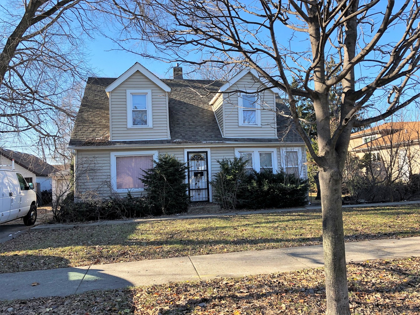 a view of a house with a yard covered with snow in the background