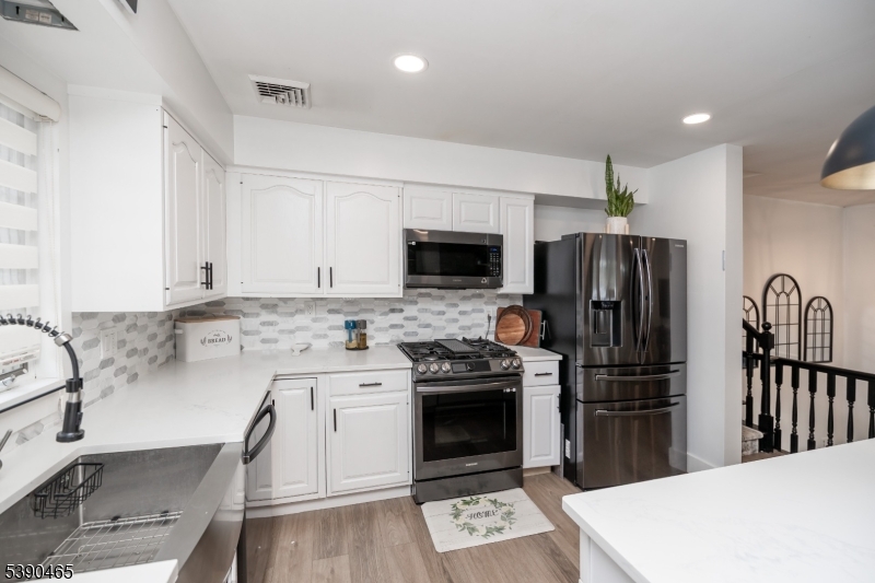 11 Washington Street Landing, NJ 07850 - Photo 12 of 45 a kitchen with a sink stainless steel appliances and cabinets