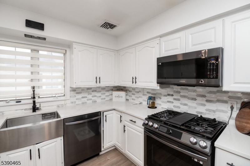 11 Washington Street Landing, NJ 07850 - Photo 13 of 45 a kitchen with stainless steel appliances a sink dishwasher stove microwave and cabinets