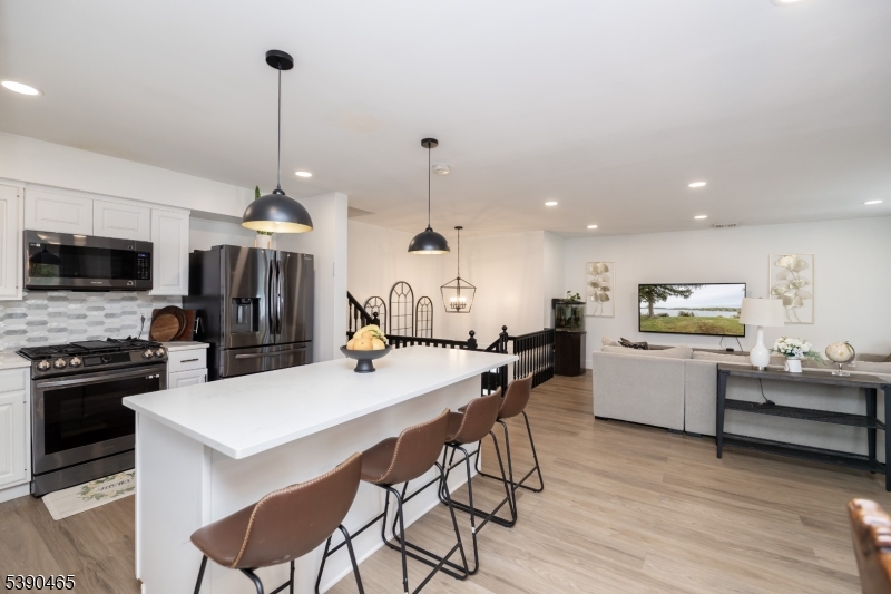 11 Washington Street Landing, NJ 07850 - Photo 14 of 45 a kitchen with a dining table chairs stainless steel appliances and cabinets