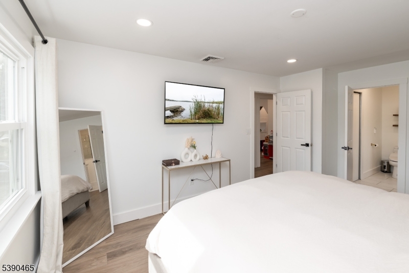11 Washington Street Landing, NJ 07850 - Photo 18 of 45 a bedroom with a bed and a flat screen tv