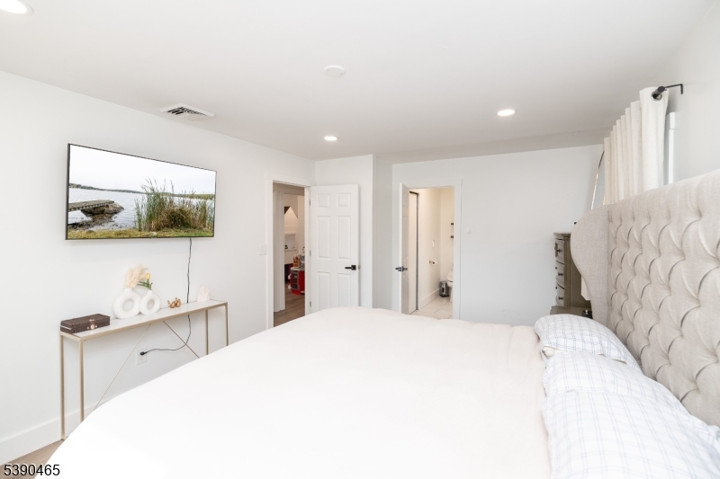 11 Washington Street Landing, NJ 07850 - Photo 19 of 45 a bedroom with a bed and a flat screen tv