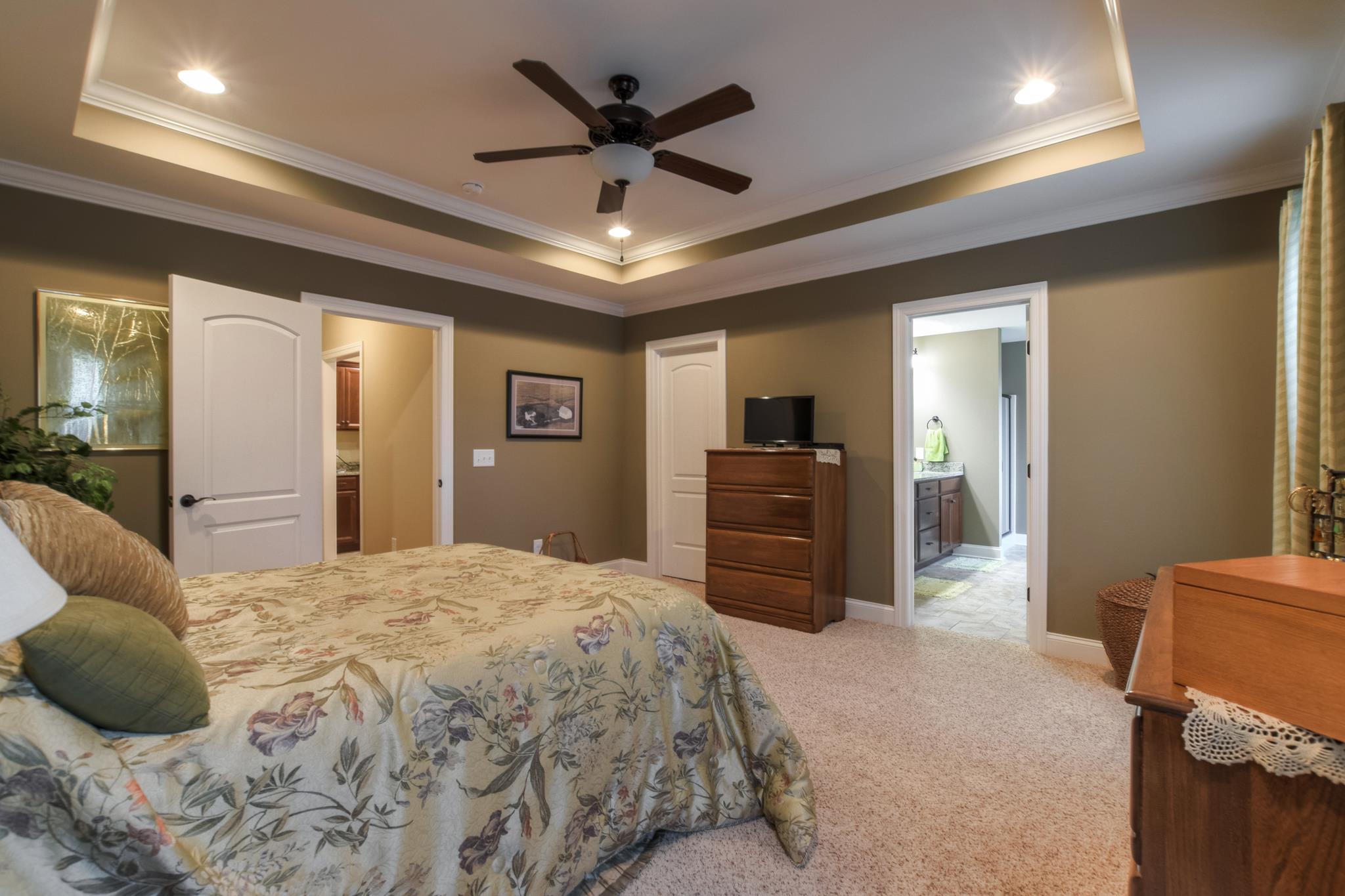 158 Abbey Road Lebanon, TN 37090 - Photo 16 of 30 a spacious bedroom with a bed a dresser and a chandelier