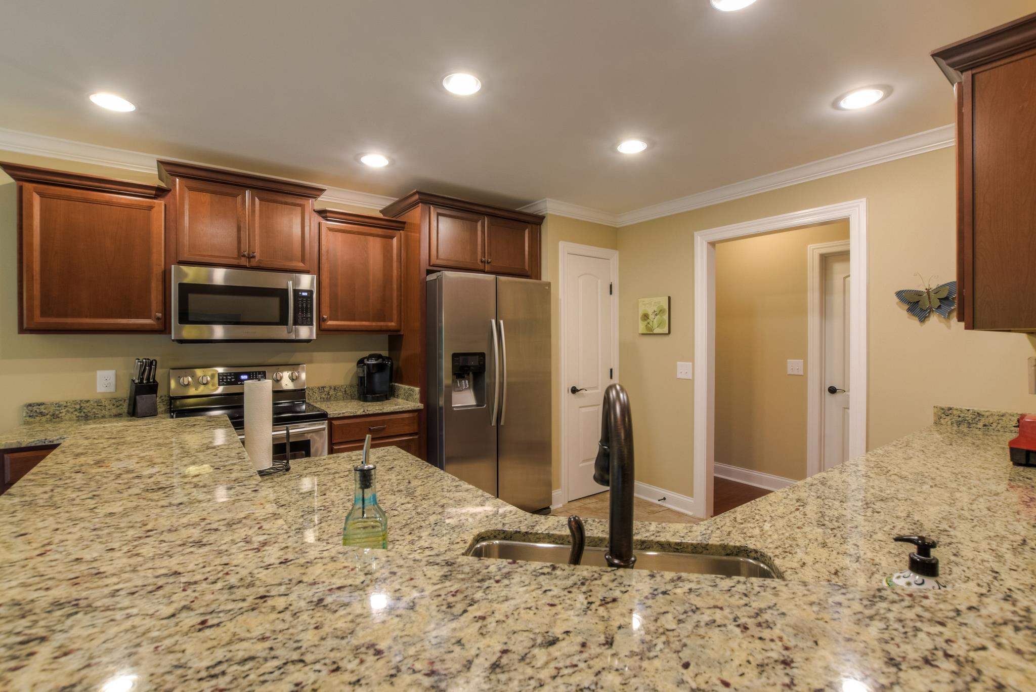 158 Abbey Road Lebanon, TN 37090 - Photo 10 of 30 a large kitchen with stainless steel appliances kitchen island granite countertop a refrigerator and a sink