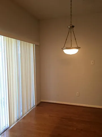 a view of a room with a window and wooden floor
