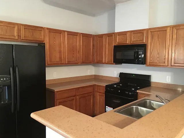 a kitchen with a sink a stove and refrigerator