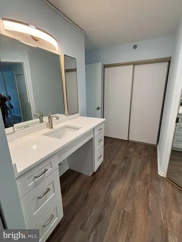 a room with a sink a vanity and a mirror