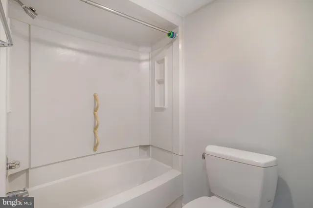 a bathroom with a toilet and bathtub
