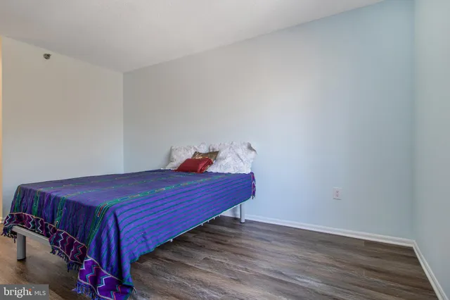 a bed room with a bed and wooden floor