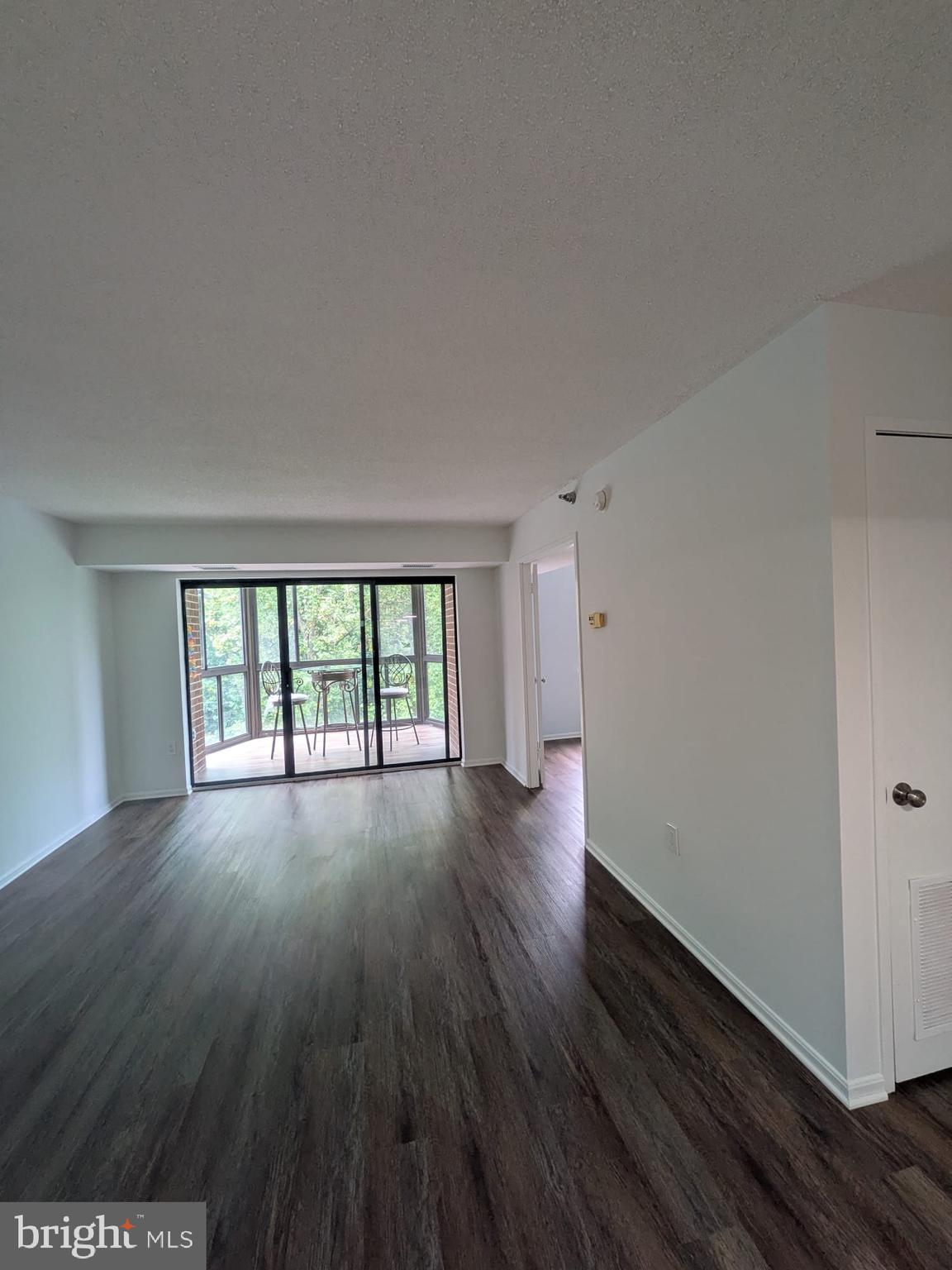 15115 Interlachen Drive, Unit 31020 Silver Spring, MD 20906 - Photo 48 of 48 an empty room with wooden floor and windows