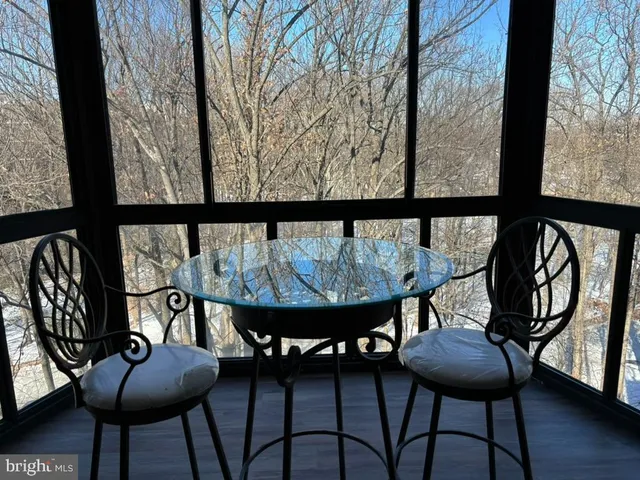 a view of a chairs and table in patio