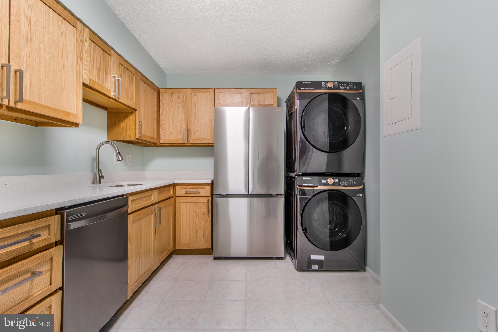 15115 Interlachen Drive, Unit 31020 Silver Spring, MD 20906 - Photo 9 of 48 a utility room with sink dryer and washer