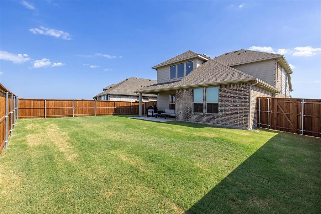 6105 Poolside Way Royse City, TX 75189 - Photo 3 of 12 a front view of a house with a garden