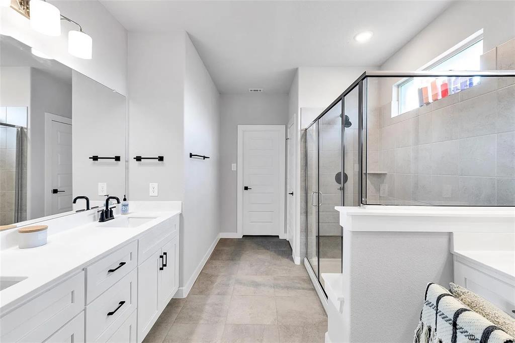 6105 Poolside Way Royse City, TX 75189 - Photo 5 of 12 a spacious bathroom with double vanity and mirrors
