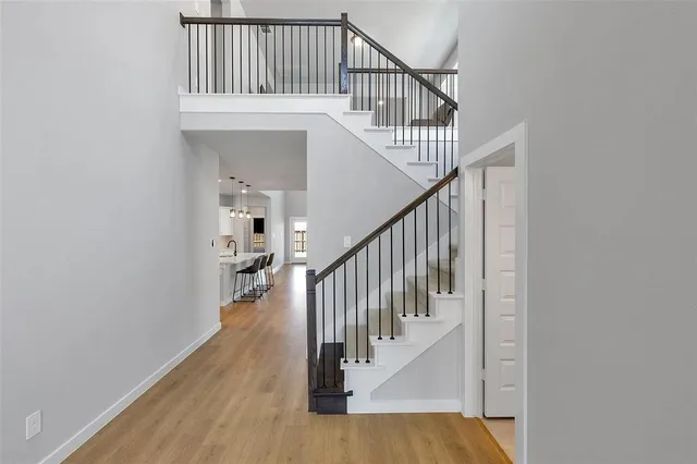 a view of staircase with railing and white walls