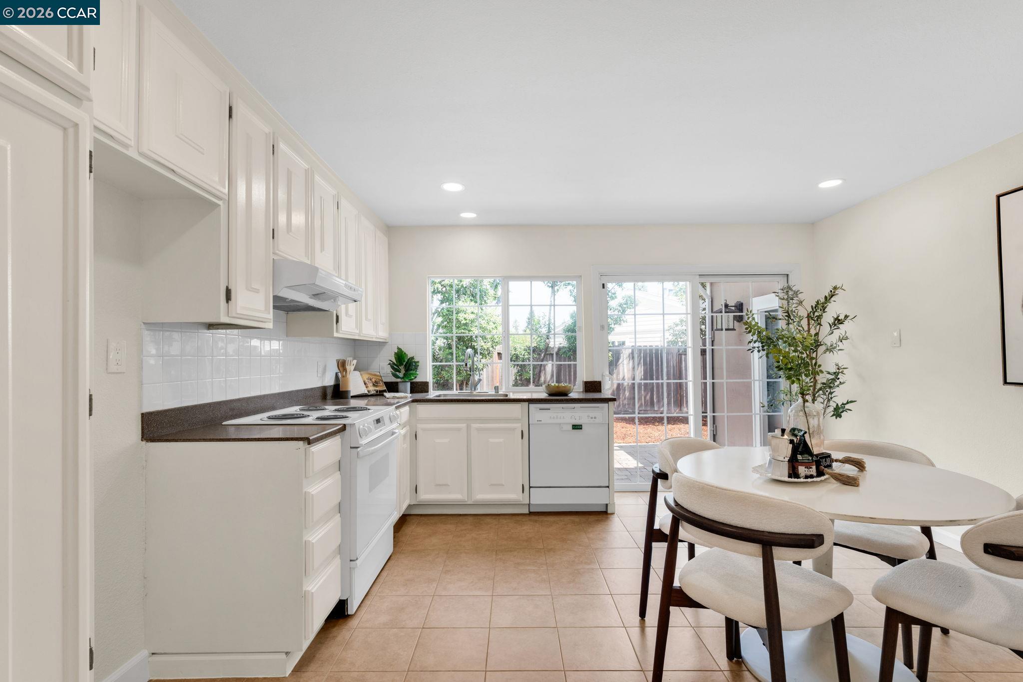 32 Yale Court San Ramon, CA 94583 - Photo 14 of 40 a kitchen with granite countertop white cabinets and stainless steel appliances